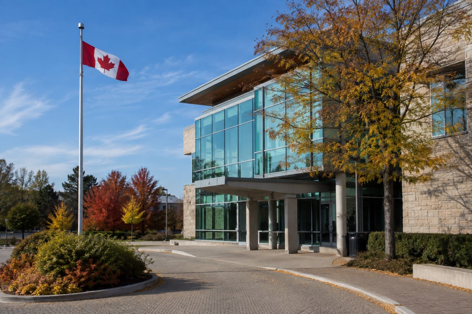 AI-generated illustration: exterior of a modern Canadian municipal town hall under a clear autumn sky